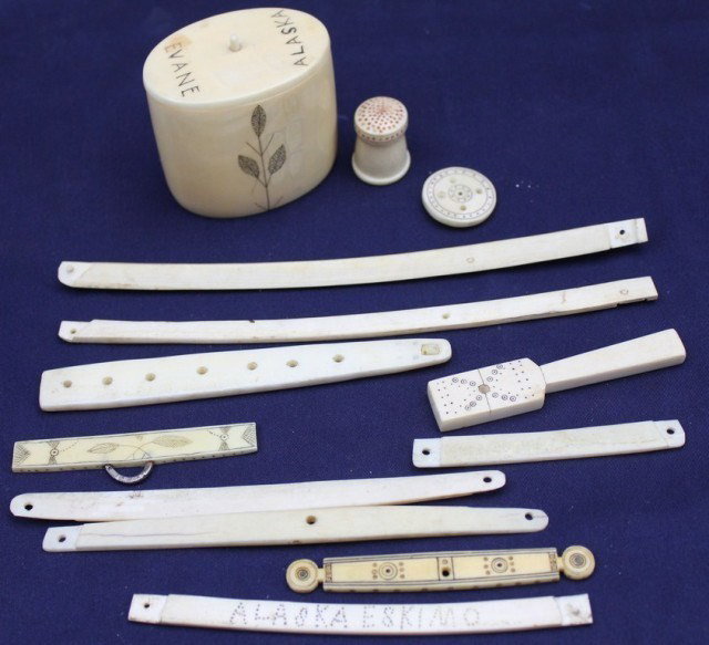 ALASKAN WALRUS TUSK IVORY & SCRIMSHAW TOOLS: ALASKAN WALRUS TUSK IVORY & SCRIMSHAW TOOLS A mixed lot to include: a thimble, button, a pat, an lidded pot and more. Many are decorated scrimshaw style. Size: various Condition: GC Lot: 15394