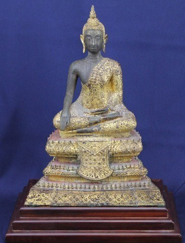 THAI CAST GILT BRONZE SEATED BUDDHA: THAI CAST GILT BRONZE SEATED BUDDHA Thai gilt bronze antique seated Buddha, a good detailed casting. Size: 14" plus wood base Condition: Some wear to gilding Lot: 15422