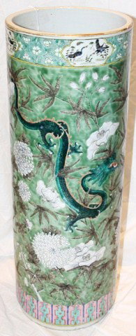 LARGE GREEN UMBRELLA STAND WITH CHINESE MOTIF: LARGE GREEN UMBRELLA STAND WITH CHINESE MOTIF Glazed umbrella stand painted with dragons, birds, and flowers. Size: 25" Condition: GC with minor crazing and cracks to base Lot: 15428a