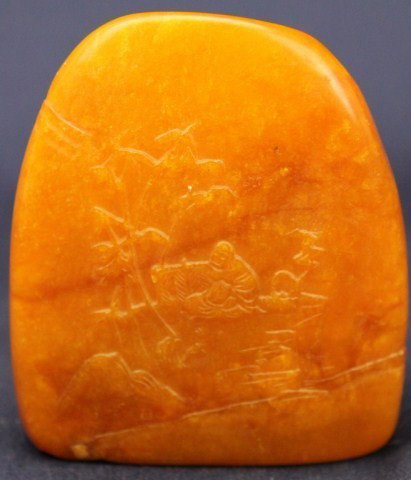 TIANHUANG BOULDER W/ BUDDHA SCENE: TIANHUANG BOULDER W/ BUDDHA SCENE A caramel colored tianhuang stone with a scene of Buddha amongst nature, carved in relief. On the reverse is an old man climbing a mountain. Size: 3.25" x 2.5" Condit
