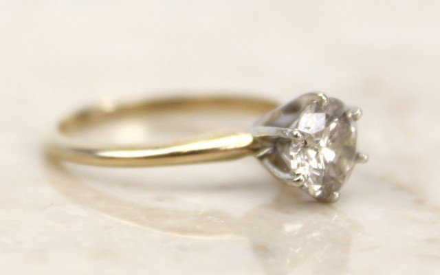 LADIES 1CT DIAMOND SOLITAIRE RING: LADIES 1CT DIAMOND SOLITAIRE RING A 14K yellow / white gold ladies diamond solitaire ring having an approximate 1ct. round solitaire of I2 / H quality. Measuring 6.9mmX3.91mm. Prong set. Weight: 2g Si