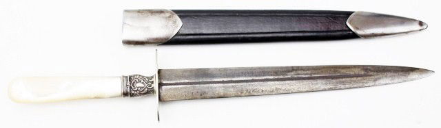WM ROGERS PEARL & SILVER MOUNTED DAGGER: WM ROGERS PEARL & SILVER MOUNTED DAGGER Early 20th century fighting knife. Double edged steel blade with central blood groove to each side. Mother of pearl grip (age cracked), sterling ferrule and whi