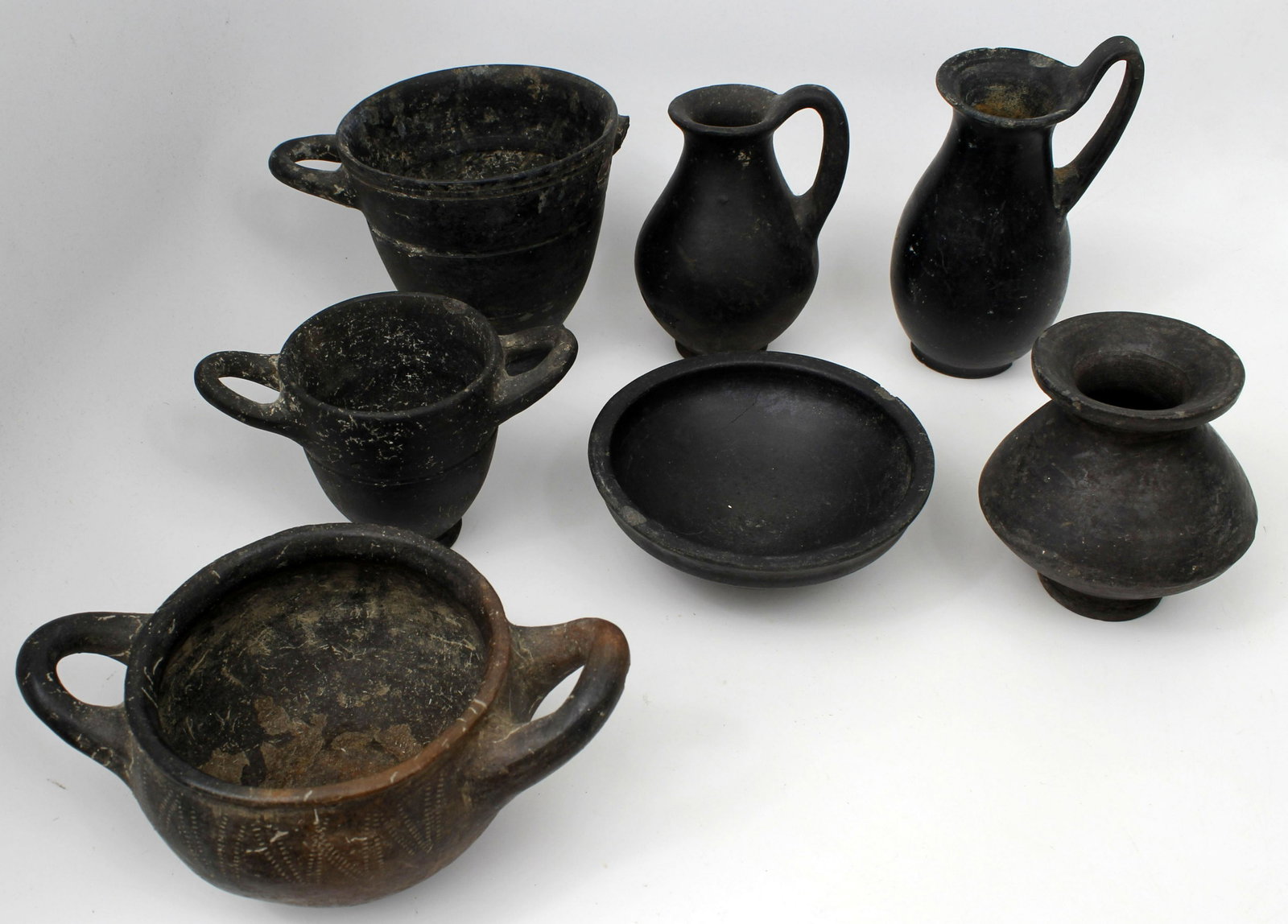 ANCIENT BLACK APULIAN POTTERY COLLECTION: Magna Graecia, South Italic Colonies, Apulia, ca. 340 to 325 BC. Collection of Black Apulian pottery, a 7 (seven) piece collection of early Black Apulian pottery toinclude (2) Oinocoe, 4x3 and 5x3", (