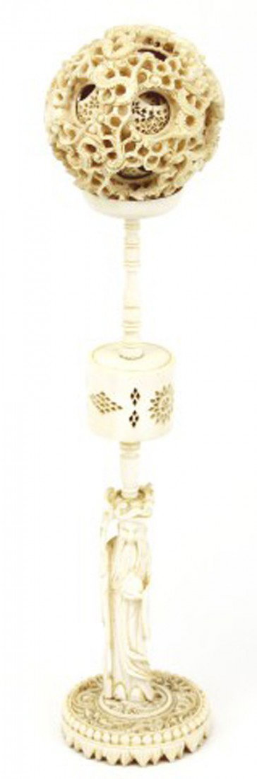 CHINESE CARVED ELEPHANT IVORY PUZZLE BALL & STAND: CHINESE CARVED ELEPHANT IVORY PUZZLE BALL & STAND A tall and finely carved Chinese puzzle ball and stand with deity figure finial. This is the puzzle ball with many layers. And carved with Dragon figu