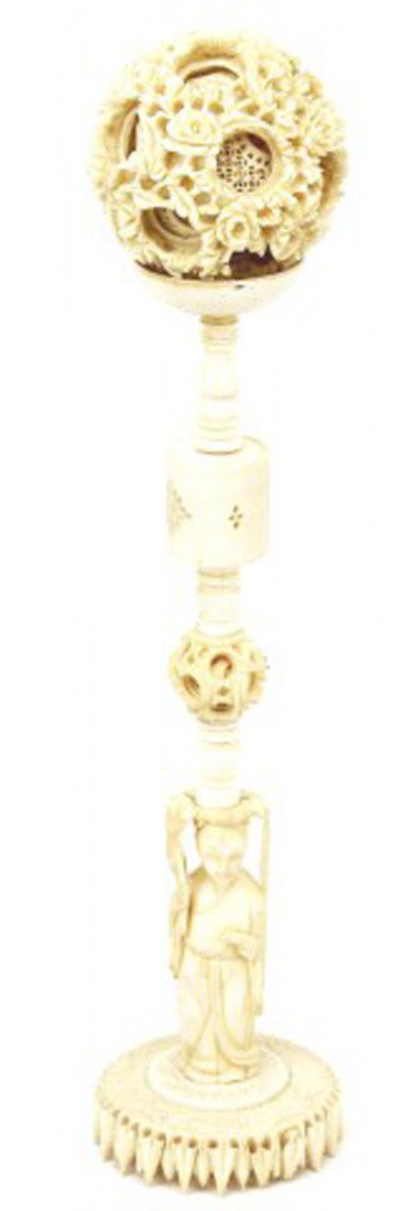 CHINESE CARVED ELEPHANT IVORY PUZZLE BALL & STAND: CHINESE CARVED ELEPHANT IVORY PUZZLE BALL & STAND A tall and finely carved Chinese puzzle ball and stand with deity figure finial. This is the puzzle ball with many layers. And carved with Dragon figu