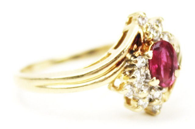 LADIES 14K GOLD RING W/ SPINEL AND DIAMOND CLUSTER: LADIES 14K GOLD RING W/ SPINEL AND DIAMOND CLUSTER An oval cut spinel is centered within a cluster of diamond chips. The stone is embedded by a prong setting. Weight: 3.9g Size: 8.5 Condition: VGC Est