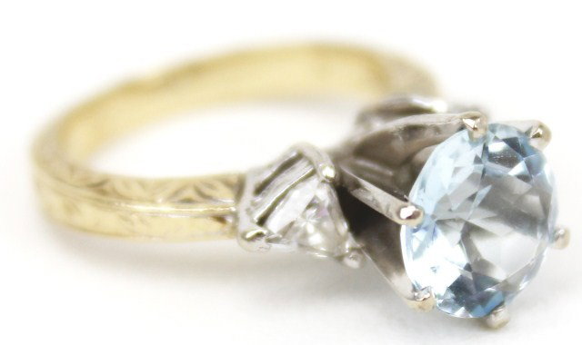 LADIES 14K GOLD AQUAMARINE AND DIAMOND RING: LADIES 14K GOLD AQUAMARINE AND DIAMOND RING A large 1.5 ct round cut aquamarine accented by 2 trillion cut diamonds of approximately 0.15 cts each. Accompanied by a September 2011 appraisal of $1,950.