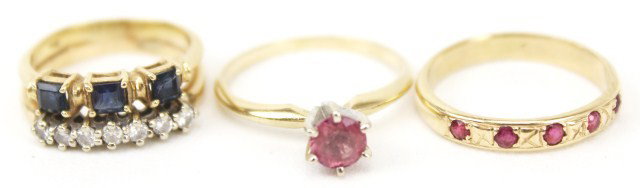 LOT 3 LADIES 14K GOLD RINGS - RUBY & SAPPHIRE: LOT 3 LADIES 14K GOLD RINGS - RUBY & SAPPHIRE A round cut ruby solitaire ring with approximately a 0.5 ct ruby. A gold band with 5 small round cut rubies. Also a double banded ring with 7 small round 