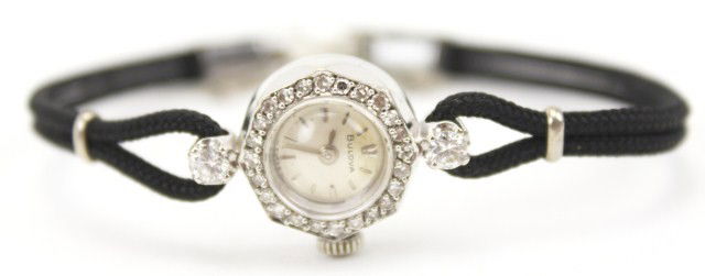 LADIES 14K WHITE GOLD 17J BULOVA WATCH: LADIES 14K WHITE GOLD 17J BULOVA WATCH Bulova 17 Jewel Swiss movement in 14K white gold case, with diamonds, No. 724535, and cloth band with white gold plated clasp. Weight: 7.8g Condition: VGC, Worki
