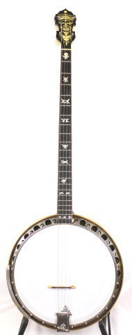 VINTAGE PARAMOUNT STYLE C 4 STRING BANJO: VINTAGE PARAMOUNT STYLE C 4 STRING BANJO A vintage Plectrum or standard banjo. 22 frets with a total neck length of 26 inches, inlaid mother of pearl scrollwork with "dove" figures and floral carving.