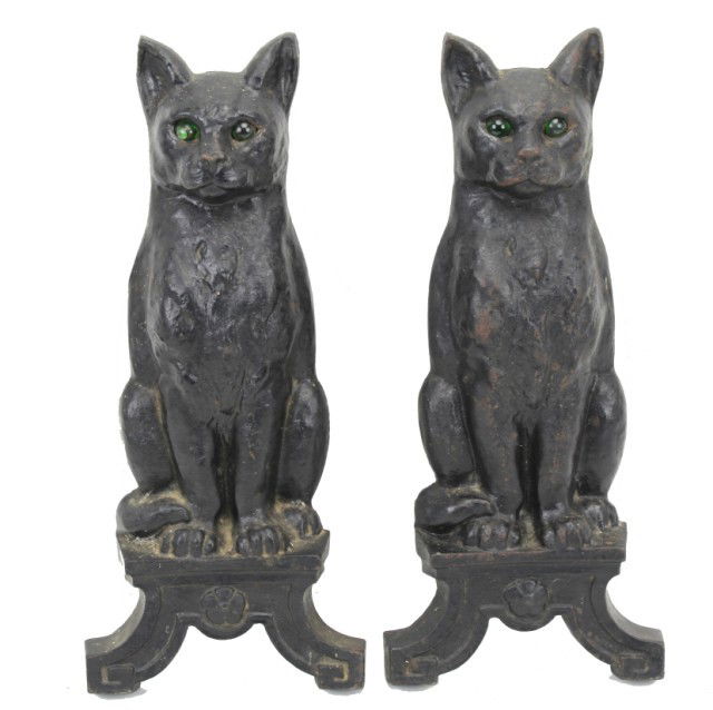 CAST IRON BLACK CAT ANDIRONS WITH GREEN GLASS EYES: CAST IRON BLACK CAT ANDIRONS WITH GREEN GLASS EYES Cast Iron Black Cat Andirons with green glass eyes. The eyes light up with the fire behind. Marked IOCOO in the back, very well cast. One of the eyes