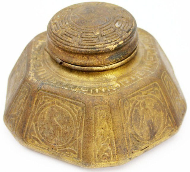 TIFFANY STUDIOS NY ZODIAC BRONZE INK WELL #1072: TIFFANY STUDIOS NY ZODIAC BRONZE INK WELL #1072 Zodiac symbol ink well manufactured by Tiffany's. The ink well is made of bronze and features 6 zodiac symbols around the outer edges. The lid has a sev