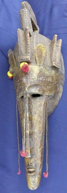 BAMBARA TRIBE CARVED WOOD MASK: BAMBARA TRIBE CARVED WOOD MASK Carved wooden African mask with metal sheet covering. Bambara tribe. Early 20th century. Size: 29" long Condition: VGC Est.150-300