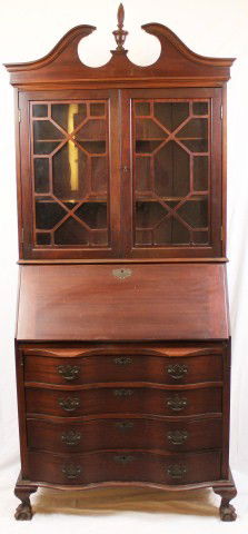 4 DRAWER MAHOGANY SECRETARY DESK: 4 DRAWER MAHOGANY SECRETARY DESK A large glass cupboard sits atop this mahogany secretary desk. The desk houses four drawers. The desk surface folds down to reveal more storage. One of the accessory d