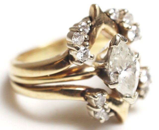 LADIES 14K GOLD 1.3CT DIAMOND RING: LADIES 14K GOLD 1.3CT DIAMOND RING A beautiful ladies diamond wedding or fashion ring. The ring is 2 part, being a marquise solitaire of approx. .8ct and SI2 / J quality fused to the enhancer. The mar