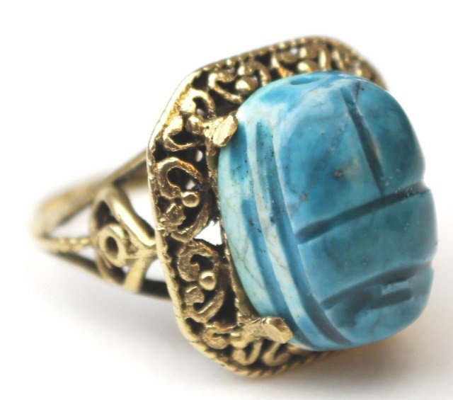 LADIES 14K GOLD SCARAB RING: LADIES 14K GOLD SCARAB RING This scarab ring features a teal stone and is set in 14K yellow gold. The scarab ring signifies a parallel between the beetle and the heavenly cycle of day and night. Weigh