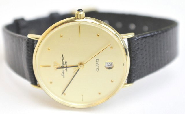 JULES JUERGENSEN 14K GOLD CASE WRISTWATCH: JULES JUERGENSEN 14K GOLD CASE WRISTWATCH Jules Juergensen wristwatch with authentic lizard skin band. The case is made of 14k yellow gold. Features time and date. Original box included. Quartz crysta