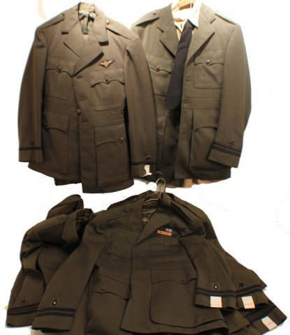 UNIFORM - 9 US NAVY OFFICERS DRESS GREEN JACKETS: UNIFORM - 9 US NAVY OFFICERS DRESS GREEN JACKETS Two with bullion pilots badges. All with sleeve insignia. Includes 3 pairs of pants and a shirt. Size: Various Condition: VG or better EST. 100-300