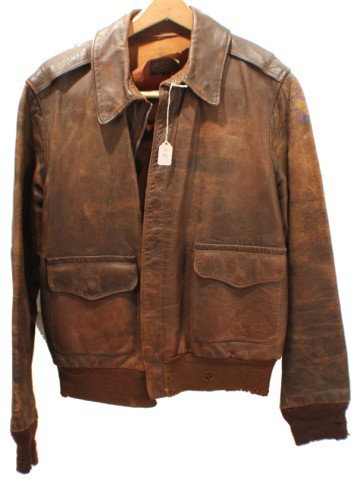UNIFORM - US AVIATOR A2 TYPE LEATHER JACKET: UNIFORM - US AVIATOR A2 TYPE LEATHER JACKET Leather flight jacket, type A2. Size 40. Rough wear clothing co. Worn, with remnants of flight insignia. Size: Various Condition: Fair/ worn EST. 100-200