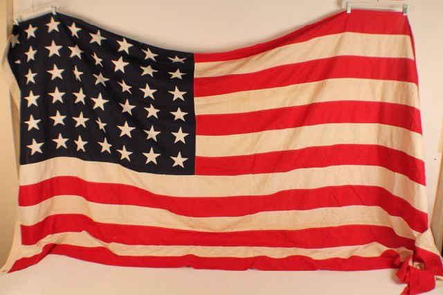 LARGE 48 STAR AMERICAN FLAG: LARGE 48 STAR AMERICAN FLAG 1912-1959. A good example of the standard flag of the period. Hessian gauze material. 5' x 8'. Condition: Good, little sign of use EST. 100-200