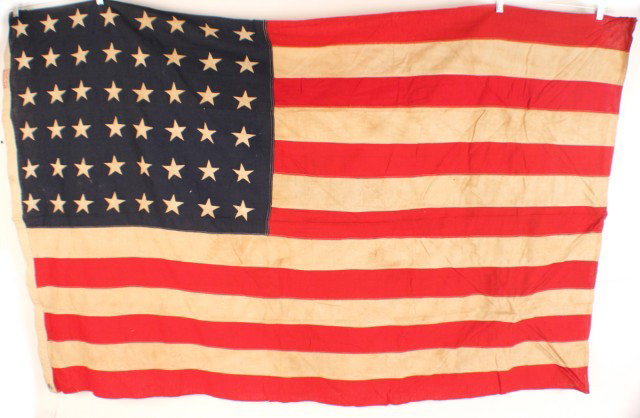 MEDIUM SIZE 48 STAR AMERICAN FLAG: MEDIUM SIZE 48 STAR AMERICAN FLAG 1912-1959. A good example of the standard flag of the period. Hessian gauze material. 5' x 3'. Condition: Good, little sign of use EST. 50-100