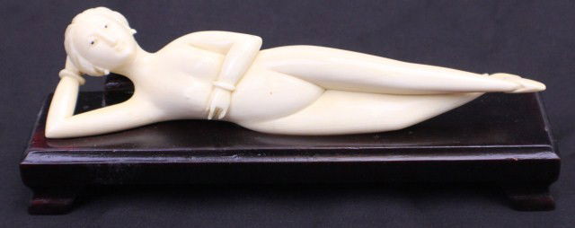 CHINESE IVORY DOCTOR'S LADY: CHINESE IVORY DOCTOR'S LADY Chinese Ivory carved Doctor's lady. Carving is nude woman reclining with hand behind her head and other hand is across her chest, on Rosewood custom stand. Size: 6.5