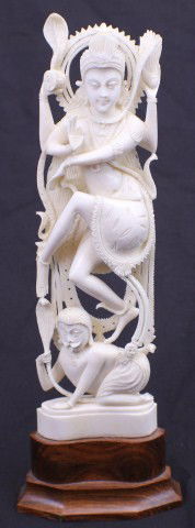 IVORY CARVING BUDDHIST GODDESS GUANYIN: IVORY CARVING BUDDHIST GODDESS GUANYIN Ivory Carving of Buddhist goddess Guanyin. Carving is 9.5" tall, mounted to a wooden base, and depicts Guanyin standing on top of a man with one foot and on a co