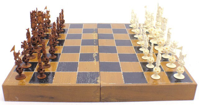 CHINESE PUZZLE BALL ELEPHANT IVORY CHESS SET: CHINESE PUZZLE BALL ELEPHANT IVORY CHESS SET Delicately carved elephant ivory chess set comprised of 32 pieces depicting various ancient Chinese figures. Each figure is surmounted on reticulated ivory