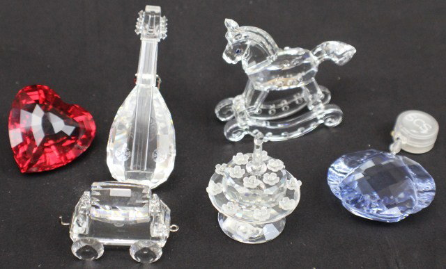 LOT 6 SWAROVSKI CRYSTAL FIGURES: LOT 6 SWAROVSKI CRYSTAL FIGURES Includes: Retired mandolin with stand, 5th anniversary birthday cake, retired rocking horse, SCS red heart member renewal gift, SCS blue water window ornament renewal g