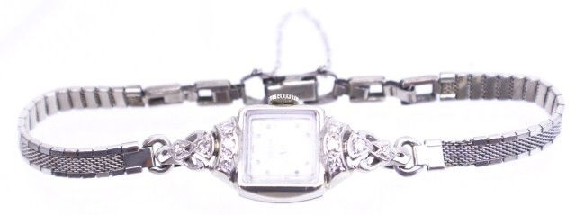 LADIES 14K WHITE GOLD AND DIAMOND BULOVA WATCH: LADIES 14K WHITE GOLD AND DIAMOND BULOVA WATCH Vintage ladies Bulova 14K white gold and diamond watch. Original movement has been replaced with quartz movement. Back is engraved H.R.L. Weight: 9.7 g (