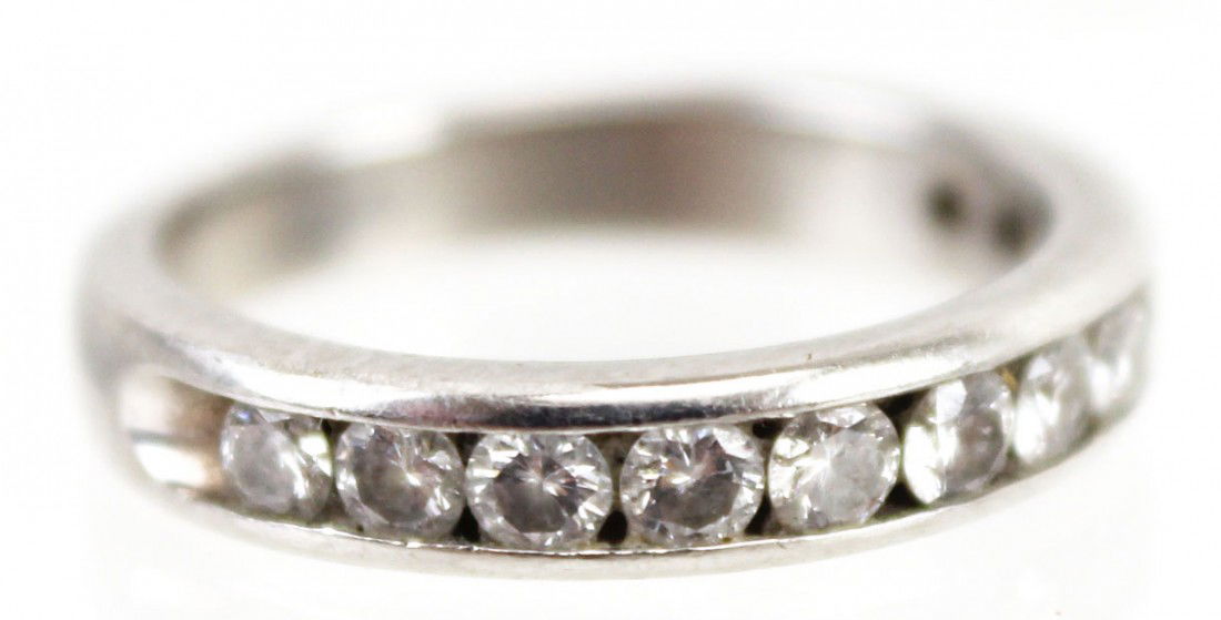 LADIES PLATINUM & DIAMOND WEDDING BAND: LADIES PLATINUM & DIAMOND WEDDING BAND Platinum and diamond wedding band with 12 channel set rounds diamonds of approximately 0.03 to 0.04 ct each, 0.4 Ctw. Weight: 4.5g Size: 4
