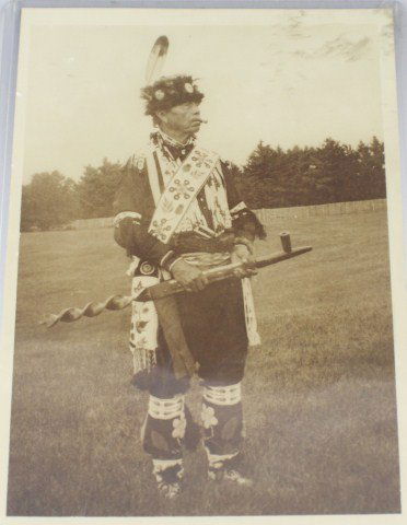 CABINET CARD OF MENOMONEE RESERVATION INDIAN: CABINET CARD OF MENOMONEE RESERVATION INDIAN This cabinet card photograph is of a Native American on the Menomonee Reservation in full ceremonial garb. He is sporting a fur hat with silver gorgets sew