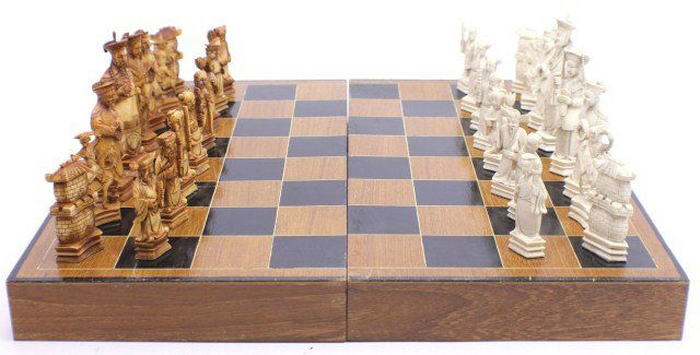 LARGE CHINESE ELEPHANT IVORY CHESS SET: LARGE CHINESE ELEPHANT IVORY CHESS SET Intricately carved Chinese elephant ivory chess set. Opponents designated by stained and original ivory coloring. Pawns are all unique to one another and generou