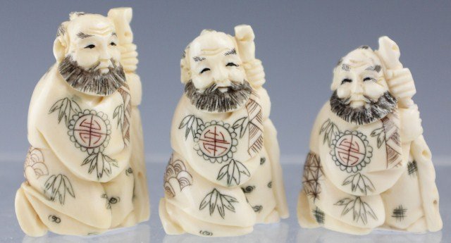 3 CARVED IVORY MALE NETSUKE: 3 CARVED IVORY MALE NETSUKE Three hand carved ivory male netsuke figures. All three are kneeling, holding staffs, bearded and wearing kimonos. Size: 1.5"