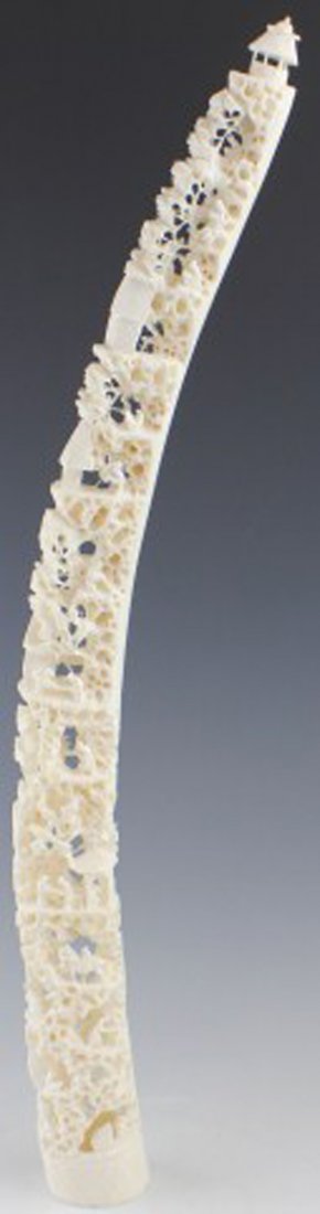 CHINESE CARVED IVORY CITY SCENE: CHINESE CARVED IVORY CITY SCENE Chinese Carved Ivory depicting a city scene. Carved from an Elephant Tusk the carving is of people in various stages of activity, such as horseback riding, piloting a b