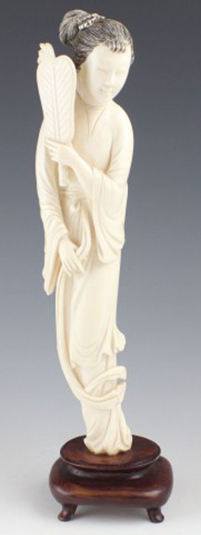 NICELY CARVED CHINESE IVORY STATUE OF A LADY: NICELY CARVED CHINESE IVORY STATUE OF A LADY Carved from ivory, a beautiful Chinese lady holding a fan. Sitting atop a wooden base. Size: 10" (excluding base)