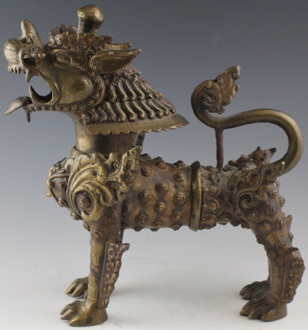 CHINESE BRONZE ARMORED FOO DOG CENSER: CHINESE BRONZE ARMORED FOO DOG CENSER Small bronze foo dog figure that may have been used as an incense burner. Size: 9.5"