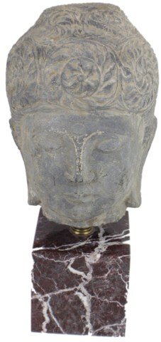 CARVED STONE BUDDHA HEAD STATUE: CARVED STONE BUDDHA HEAD STATUE Buddha head in carved stone sat atop a purple/red marble base. Some light wear marks. Size: 17"