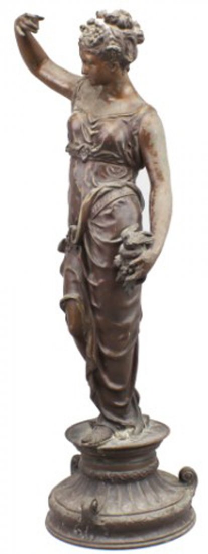 SPELTER GREEK FEMALE STATUARY: SPELTER GREEK FEMALE STATUARY Female figure depicted wearing a robe and sandals, holding a birds nest with bird in left hand and raising the right hand. There is damage to the right hand, as well as p
