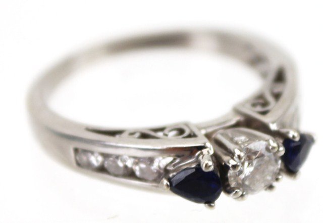 LADIES 14K WHITE GOLD SAPPHIRE & DIAMOND RING: LADIES 14K WHITE GOLD SAPPHIRE & DIAMOND RING 0.33 ct round cut diamond flanked by 2 pear cut sapphires and accented by 8 round diamonds. Approximately 0.6 Ctw in diamonds. Size: 8 Weight: 4.8g