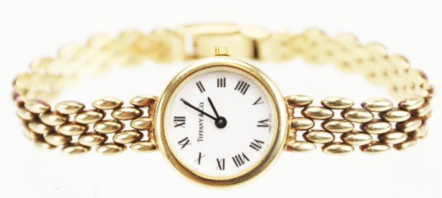 LADIES 14K GOLD TIFFANY & CO WRIST WATCH: LADIES 14K GOLD TIFFANY & CO WRIST WATCH Beautiful 14K yellow gold ladies Tiffany & Co wristwatch. White face with black roman numeral markers and batons. Inside back case is marked T980003. Back of c