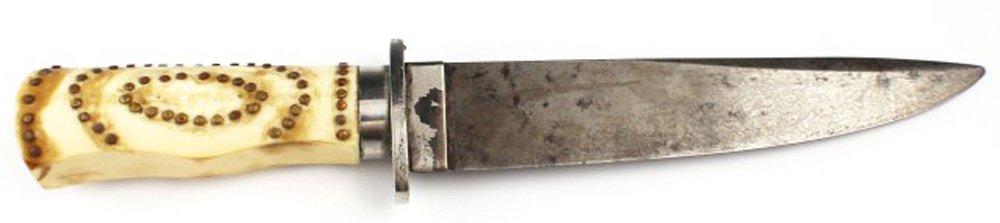 MID 19TH CENTURY IVORY HANDLE BOWIE KNIFE: MID 19TH CENTURY IVORY HANDLE BOWIE KNIFE Blade of 7.75". White metal cross guard. Petrified mammoth tusk grip (Minor age splitting). Brass studs. Thick blade, possibly a cut down sword. Size: 11.5" o