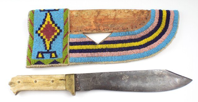 INDIAN AGENT NATIVE AMERICAN BONE HANDLE KNIFE: INDIAN AGENT NATIVE AMERICAN BONE HANDLE KNIFE Heavy weight blade of 9". Brass guard with US stamp and engraved "Standing Rock Indian Agents". Bone scales. Hard leather and bead sheath. Size: 14" over