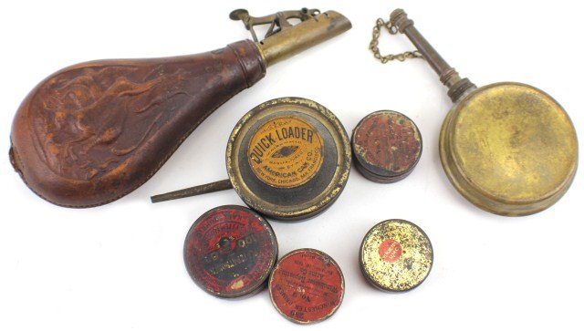 19TH CENTURY AMMUNITION LOT: 19TH CENTURY AMMUNITION LOT Lot of four percussion cap cans, two quickloaders and a decorated leather shot flask. Of the percussion cap, or primer cans, two are winchester, one is remington and the la