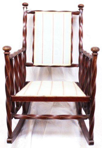 20TH CENTURY UPHOLSTERED ROCKING CHAIR: 20TH CENTURY UPHOLSTERED ROCKING CHAIR Rocking chair has a twisted-wood design. Padding is teal with dark salmon colored stripes and a pale yellow trim. A couple small stains on seat. Size: 22.75''X29