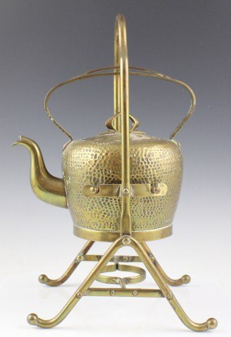 VINTAGE COPPER & BRASS LIDDED KETTLE ON STAND: VINTAGE COPPER & BRASS LIDDED KETTLE ON STAND Vintage Arts and Crafts Hammered Copper & Brass Lidded Kettle on Stand 1 1/2 L. Stamped CBN makers mark on bottom. Patina occurring in various places.