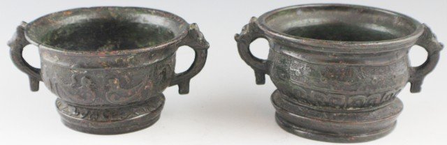 PAIR OF CHINESE ARCHAIC BRONZE RITUAL FOOD GUI: PAIR OF CHINESE ARCHAIC BRONZE RITUAL FOOD GUI PAIR OF CHINESE ARCHAIC BRONZE GUI, Western Zhou. With horned animal-form handles, bird and fish, and scroll decoration. Signed to the base. Size: 3.5" d