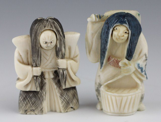 TWO SIGNED CARVED IVORY ROTATING HEAD NETSUKE: TWO SIGNED CARVED IVORY ROTATING HEAD NETSUKE One carved elephant ivory netsuke holding a fan and a basket, hair stained blue and complete with a rotating head depicting happiness or anger. One carved