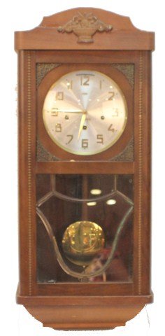 MODERN GERMAN WALL CLOCK: MODERN GERMAN WALL CLOCK A wood case wall clock in typical German style. C1970s. Size: 13" x 7" x 30" tall