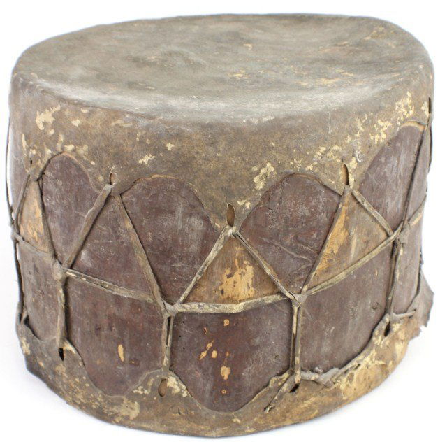 19TH CENTURY LAKOTA NATIVE AMERICAN ANTIQUE DRUM: 19TH CENTURY LAKOTA NATIVE AMERICAN ANTIQUE DRUM Rare early 19th century Elk hide double sided drum, colored with a mineral based paint. Provenance: From Rocky's Indian Museum, Florida. Size: 15" diam